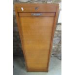 An oak framed floor standing pedestal filing cabinet enclosed by a rise and fall tambour door, the