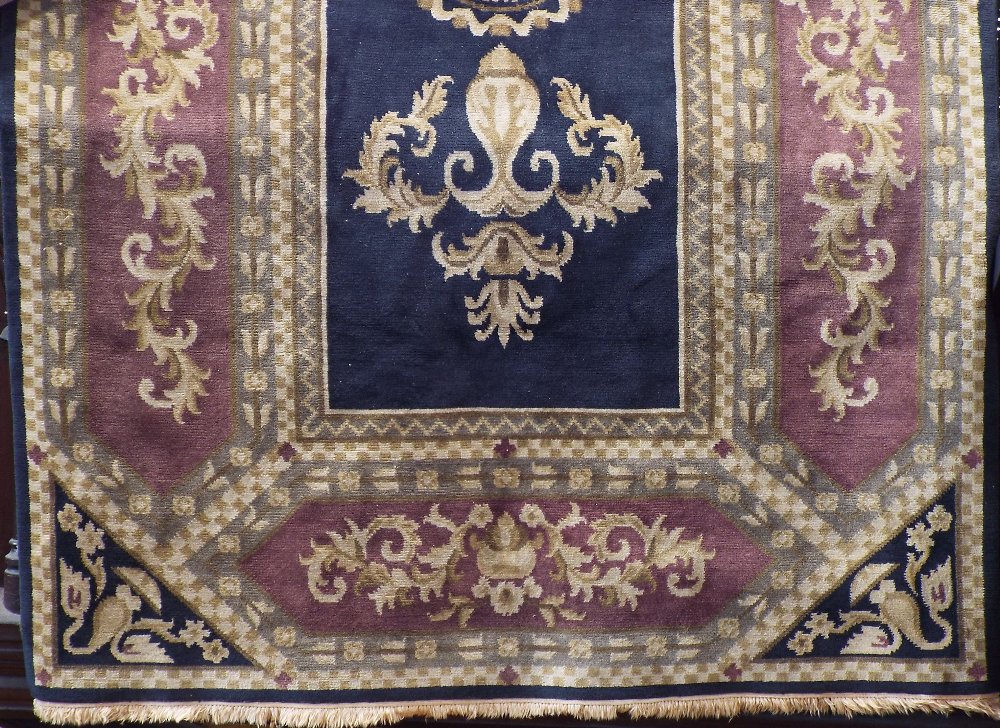 A Belgian type full pile carpet with classical scrolled acanthus stylings upon a black ground, 280 x