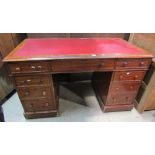 A Victorian mahogany pedestal writing desk fitted with an arrangement of nine drawers on a plinth
