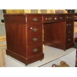 A late Victorian walnut twin pedestal writing desk fitted wit the usual arrangement of nine frieze