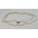 Antique single strand graduated pearl necklace, the gold clasp set with a square cluster of diamonds