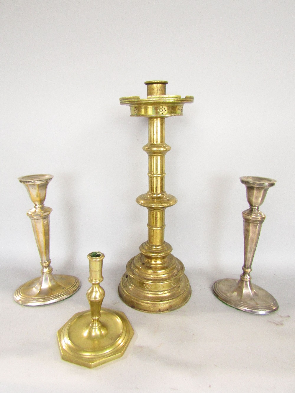 Ecclesiastical brass candlestick with turreted sconce and turned column, 47cm high; together with