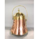 A 19th century polished copper and brass peat bucket with domed lid with swing handle