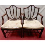 A pair of Georgian mahogany shield back open armchairs, the splats with harebell and other carved