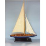 A vintage style single mast pond yacht on a polished timber base