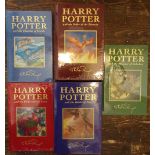 A collection of the first five Harry Potter titles, all deluxe editions with intact original plastic