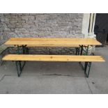 A folding trestle German picnic beer hall table with pine top, together with a pair of matching