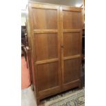 Heal's of London fumed oak gentleman's wardrobe, the twin panelled doors enclosing an interior