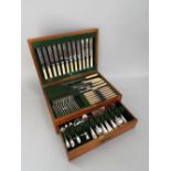 An oak canteen containing a quantity of plated flatware, the canteen fitted with a lower drawer to