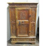 A 17th century pine side cupboard of continental origin, the central door with ironwork fittings,