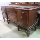 A substantial Edwardian walnut shallow inverted breakfront sideboard with applied split bead work