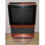 A Bang and Olufsen Beo Centre AV5 TV and stand, with metallic orange coloured trim and revolving