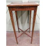 An Edwardian occasional table of square cut form raised on four slender square taper legs, united by