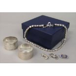 Boxed Dower & Hall sterling silver bead necklace, together with two engine turned silver napkin