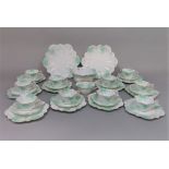A collection of Foley china teawares with green printed daisy detail comprising milk jug, slop bowl,