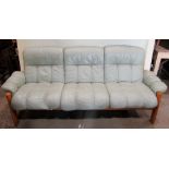 An Ekornes Stressless three seat sofa, with soft mint green stitched leather loose cushions,