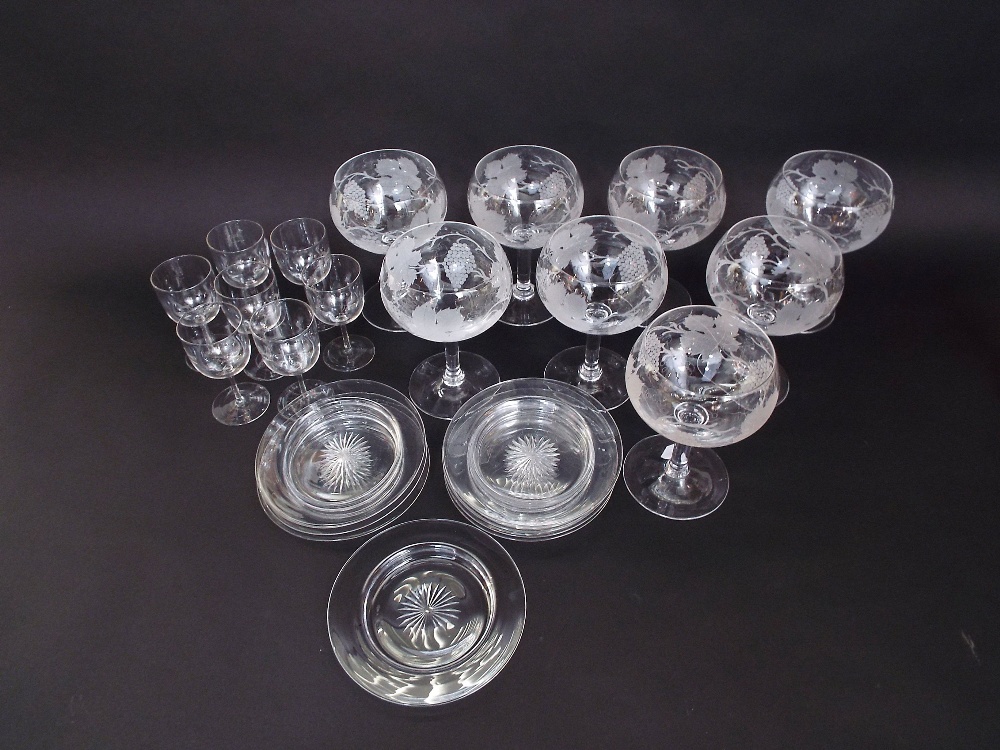 A set of eight large drinking glasses with etched fruiting vine decoration, together with a