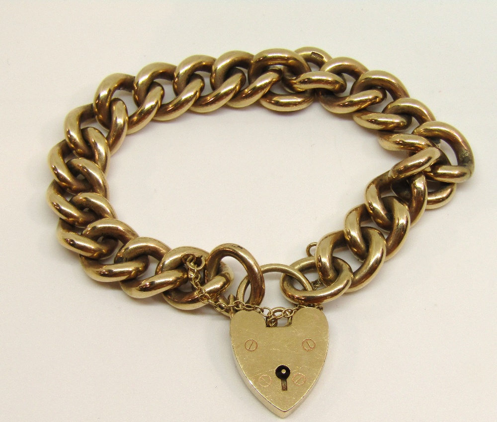 Substantial 9ct curb link bracelet with heart padlock clasp, 63.4g