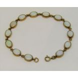 9ct opal bracelet set with thirteen oval opals, 19cm long approx, 8.2g