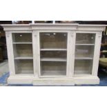 A mid-19th century breakfront three door cabinet, with gesso detail and later painted finish,