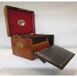 A 19th century walnut travelling box, the rising lid revealing a cushioned interior, segmented tray,