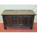 An 18th century oak panelled coffer, the front elevation with repeating Tudor rose and floral
