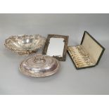 A collection of plated wares including an oval basket with embossed detail, an entree dish and