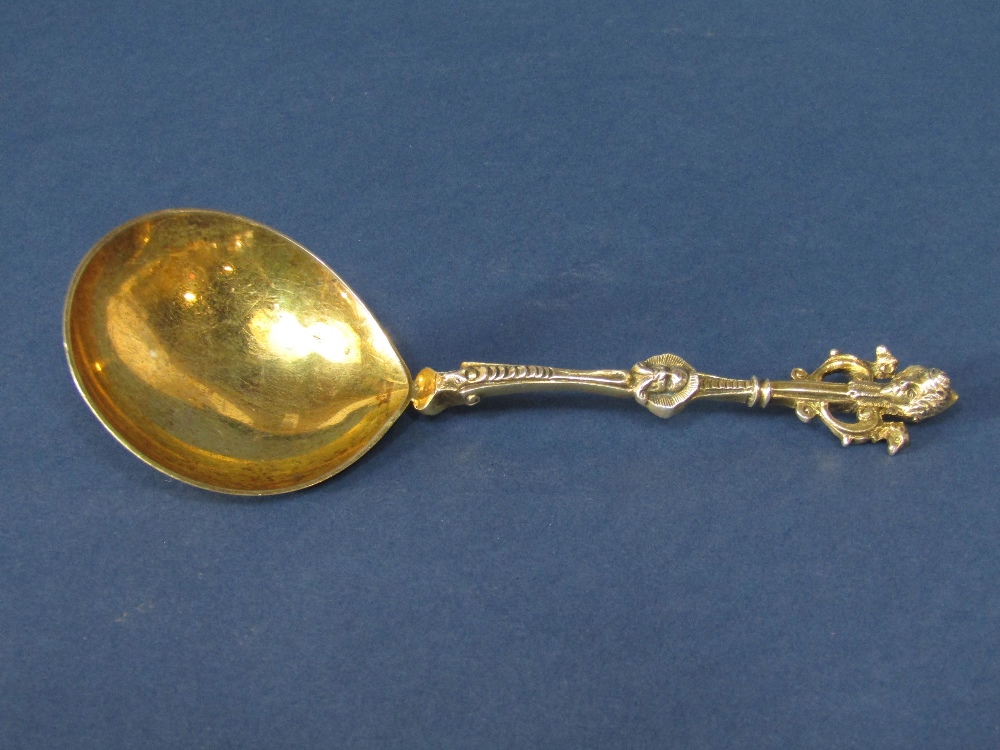 Good quality Victorian silver gilt spoon, the handle cast in the Adam style with masks and round