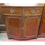 A Georgian mahogany bow fronted linen press, the lower section enclosed by two panel doors with