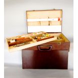 A travelling case containing a collection of fly fishing effects, ties, hand tools, etc