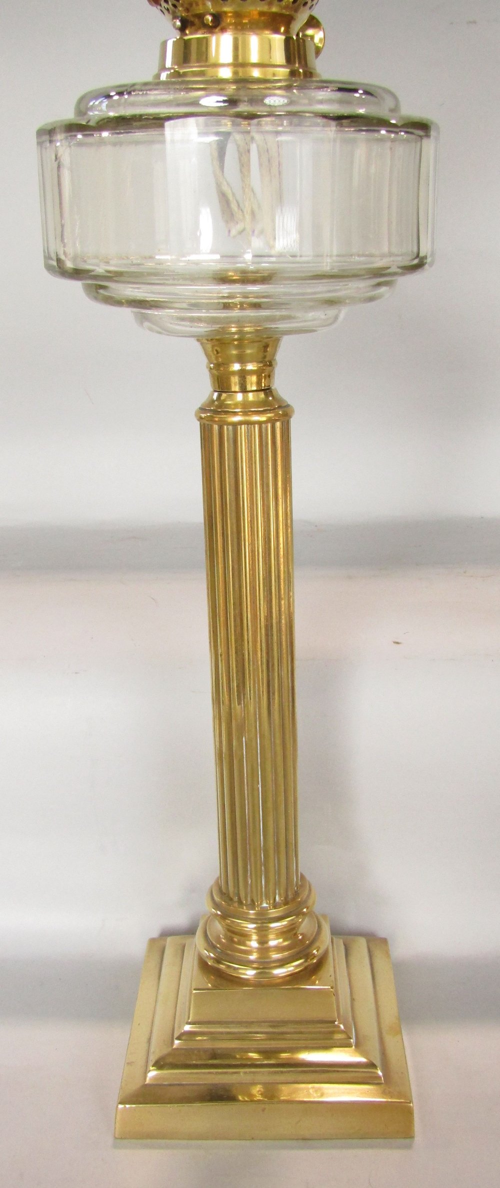 A brass table standing oil lamp, the reeded column on a stepped frame with moulded glass font, - Image 3 of 3