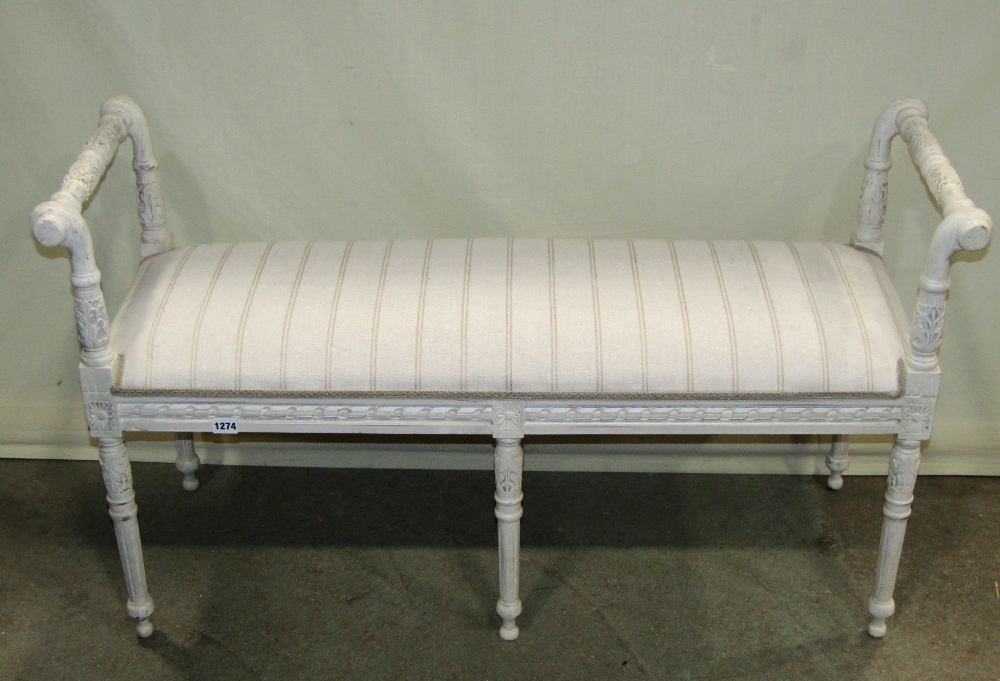 A window/duet stool of rectangular form with upholstered seat, painted frame and carved foliate
