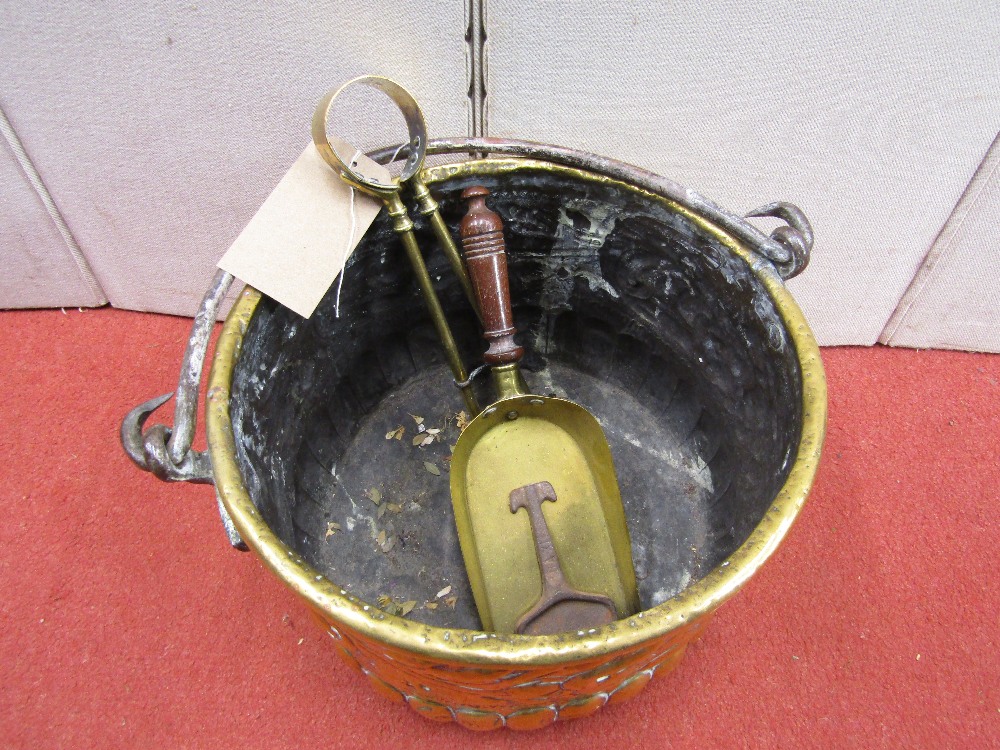 An antique embossed brass cauldron of circular form with steel loop handle, with trailing floral and - Image 2 of 2