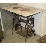 A vintage Singer cast iron treadle sewing machine base, with associated rectangular carrera marble