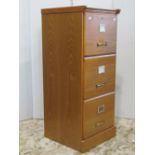 A contemporary light oak veneered three drawer pedestal filing cabinet with index drawers, 100cm