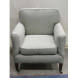A good quality late Victorian/Edwardian low armchair with later pale green upholstery, loose seat