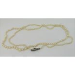 Antique single strand graduated pearl necklace, the white metal clasp set with diamond chips, 53.5cm