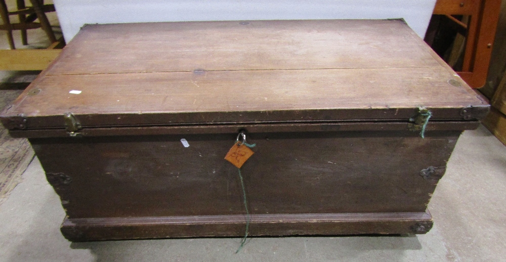 A 19th century travelling trunk with steel banded corners, carrying handles, etc