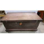 A 19th century travelling trunk with steel banded corners, carrying handles, etc
