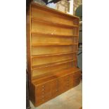 A vintage two sectional floorstanding office bookcase, the upper section recessed and enclosed by