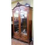 A substantial good quality continental mahogany hanging cupboard with serpentine moulded sides, th