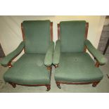 A graduated pair of Victorian drawing room chairs with carved showwood frames upholstered seat, back