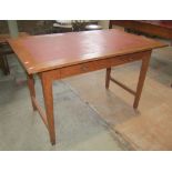 A teak desk, the rectangular overhanging top with inset writing surface, over two frieze drawers,