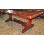 A substantial ironwood refectory table, the rectangular planked top with cleated ends raised on a