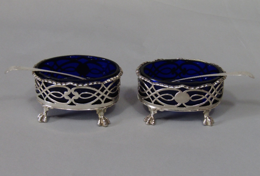 Pair of early George III silver salts with original blue glass liners, with raised geometric pierced