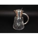 A substantial glass jug with etched fruiting vine detail and inner cooling cavity, with plated mount