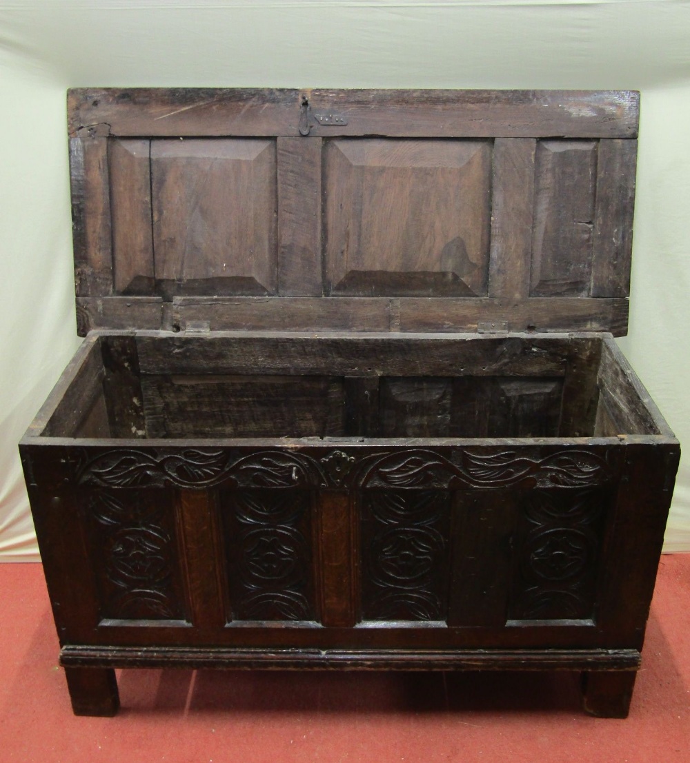 An 18th century oak panelled coffer, the front elevation with repeating Tudor rose and floral - Image 2 of 4