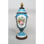 A 19th century two handled lamp base in the form of a vase and cover, with painted floral panels