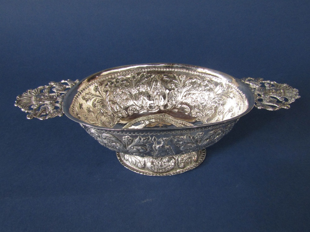 Dutch import silver twin handled quaiche/dish embossed with figures amidst foliage, maker BHJ,