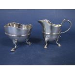 Late Victorian silver embossed banded wavy rim milk jug and sucrier, with cabriole hoof spade